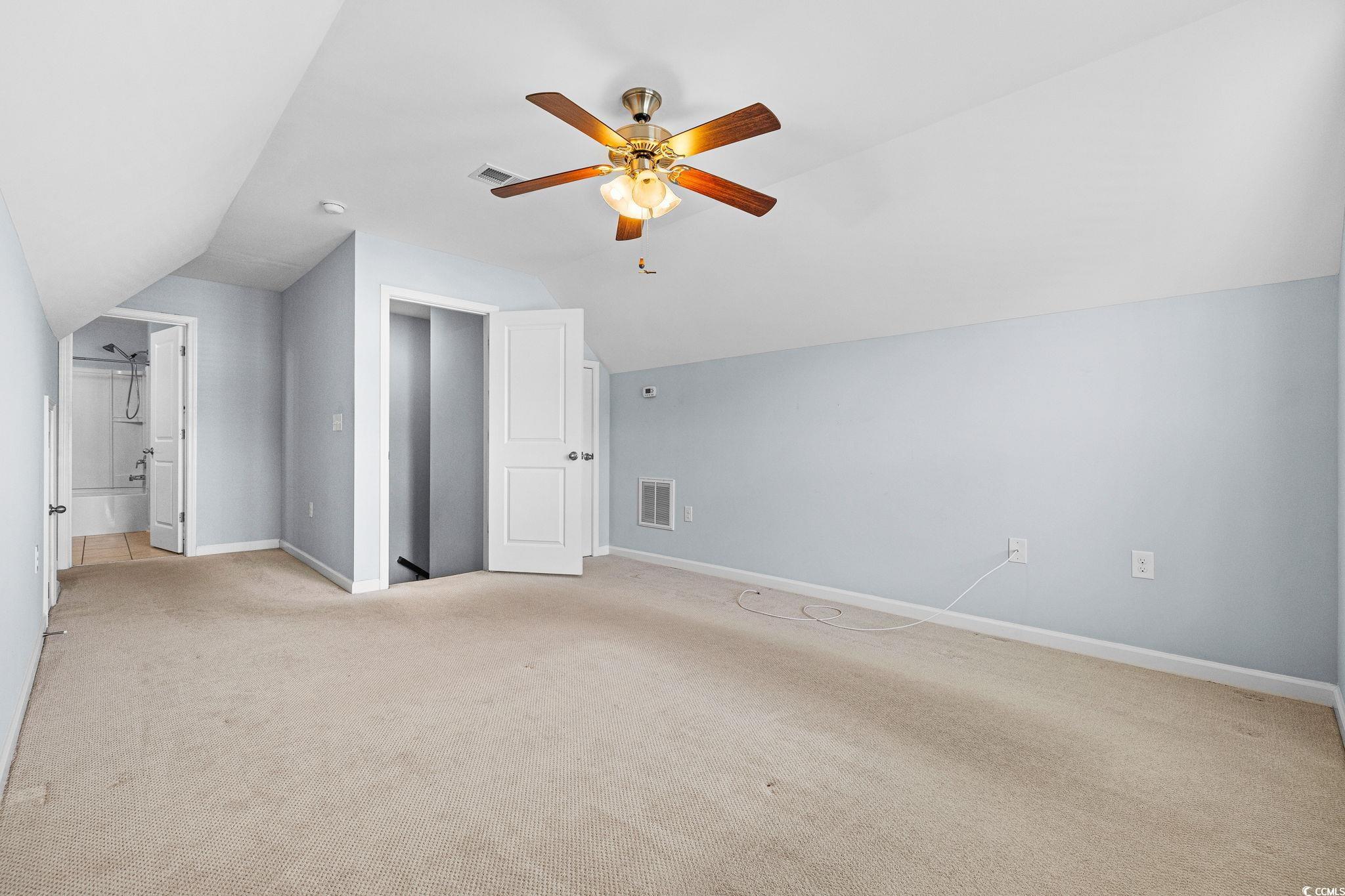 817 Arezzo Way, Unit 1001 Myrtle Beach, SC 29579 - Photo 31 of 40 Bonus room with light carpet, lofted ceiling, and a ceiling fan