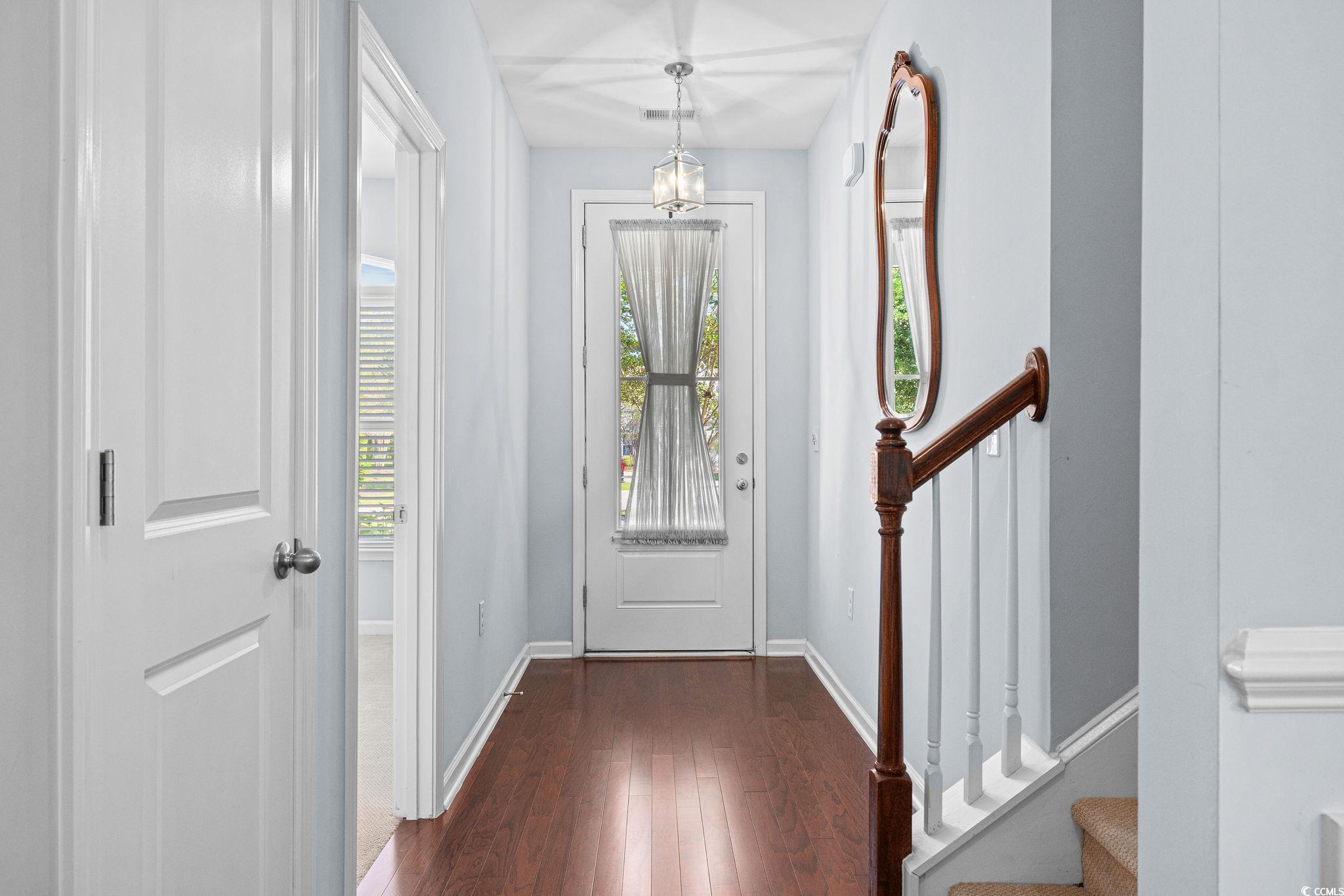817 Arezzo Way, Unit 1001 Myrtle Beach, SC 29579 - Photo 4 of 40 Foyer with dark wood-style floors, stairs, and a chandelier