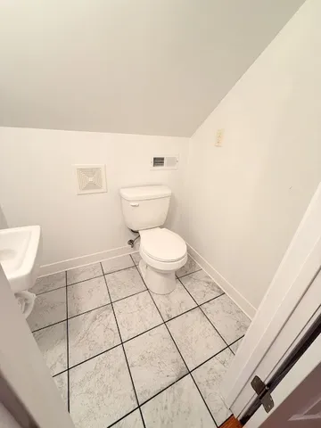 a bathroom with a toilet and a washing machine