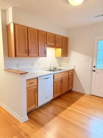 a kitchen with a sink cabinets and window