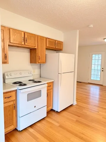 a kitchen with a stove a refrigerator and a sink