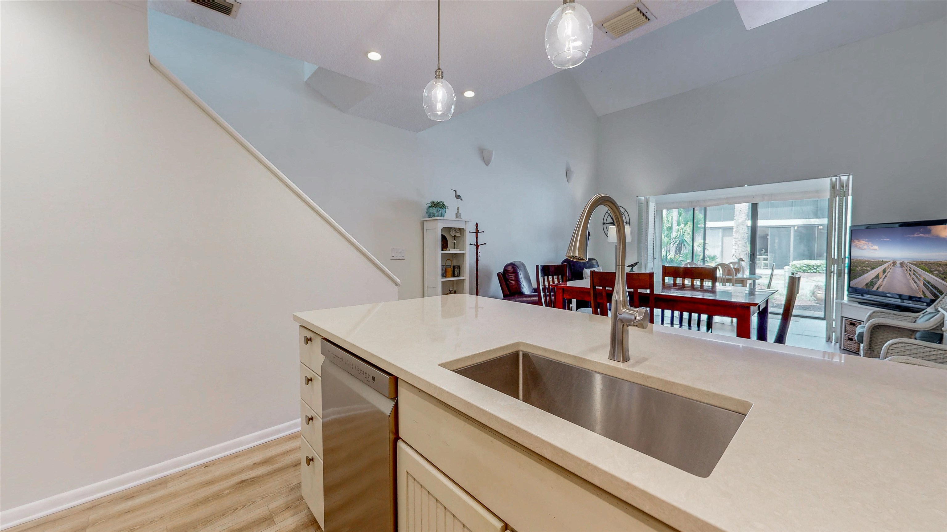 82 Village Las Palmas Circle St. Augustine, FL 32080 - Photo 16 of 58 Kitchen featuring dishwasher, light wood finished floors, light stone countertops, hanging light fixtures, and lofted ceiling