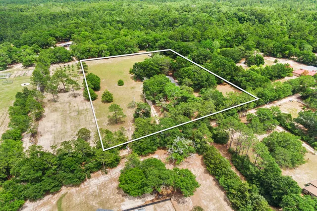 an empty room with fireplace and wooden floor
