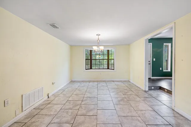 a view of a room with a ceiling fan and a chandelier fan