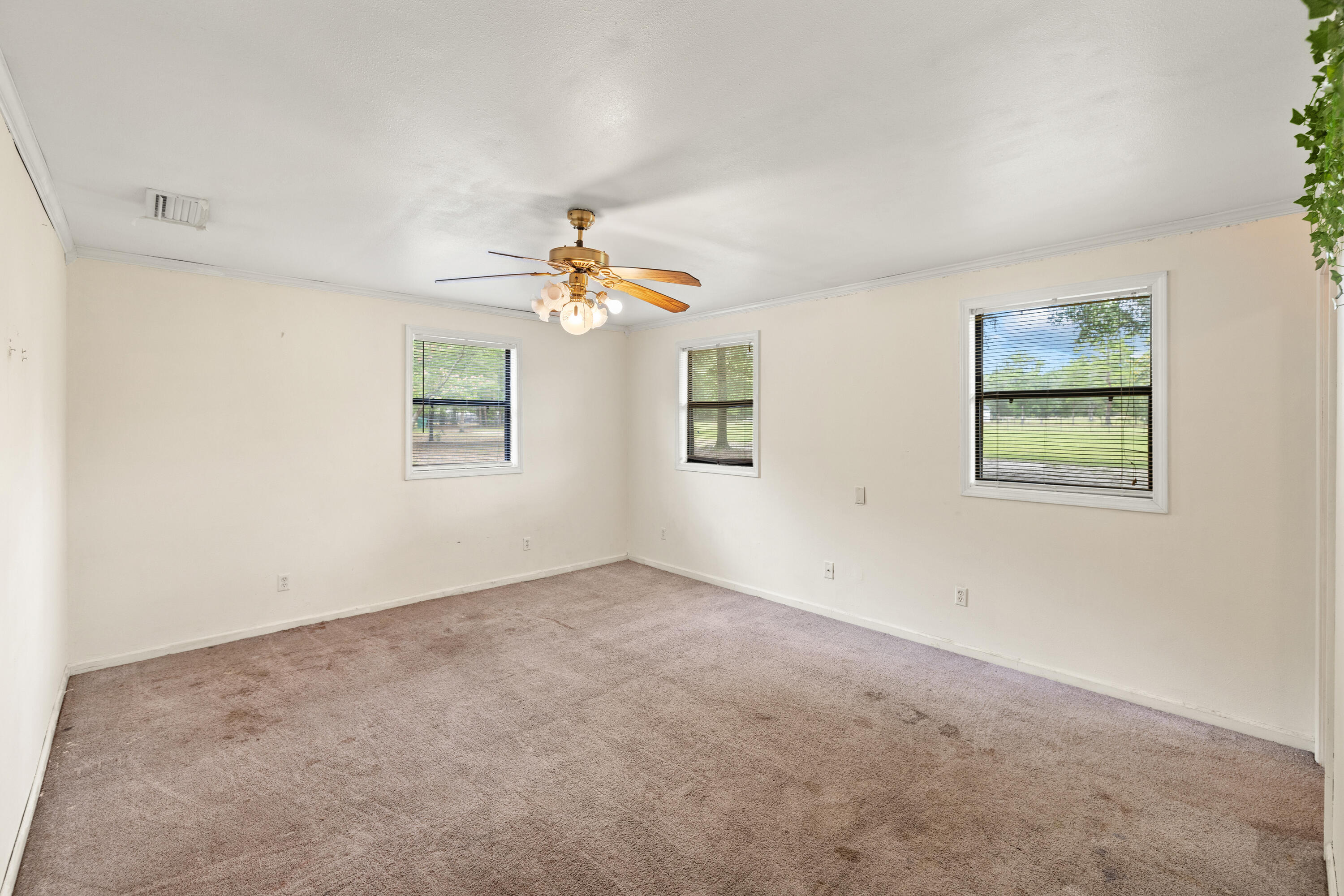 540 John King Road Crestview, FL 32539 - Photo 33 of 59 an empty room with windows and chandelier fan