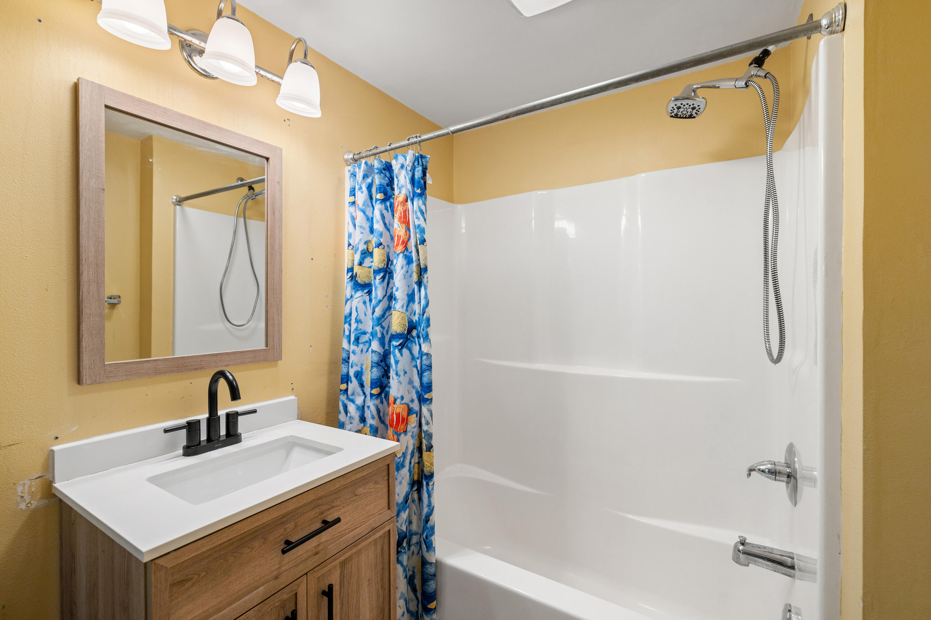 540 John King Road Crestview, FL 32539 - Photo 46 of 59 a bathroom with a sink a mirror and a shower