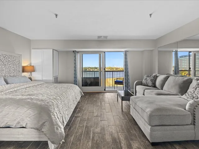 a spacious bedroom with a large bed and a large window