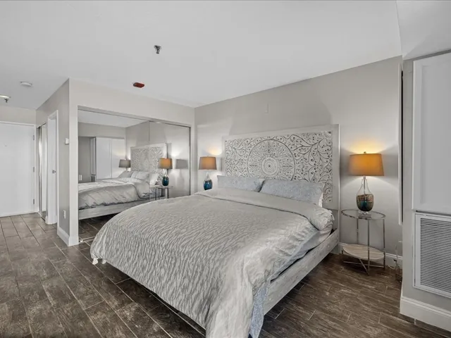 a large bedroom with a large bed and a large window