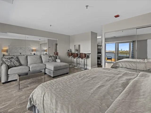 a large bedroom with a bed and glass table