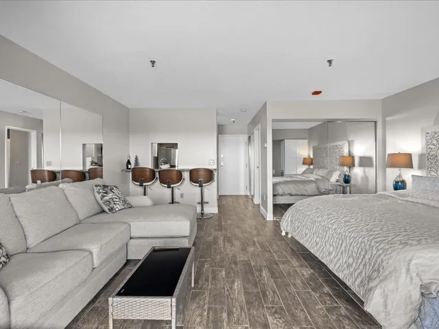 a bedroom with a bed and wooden floor