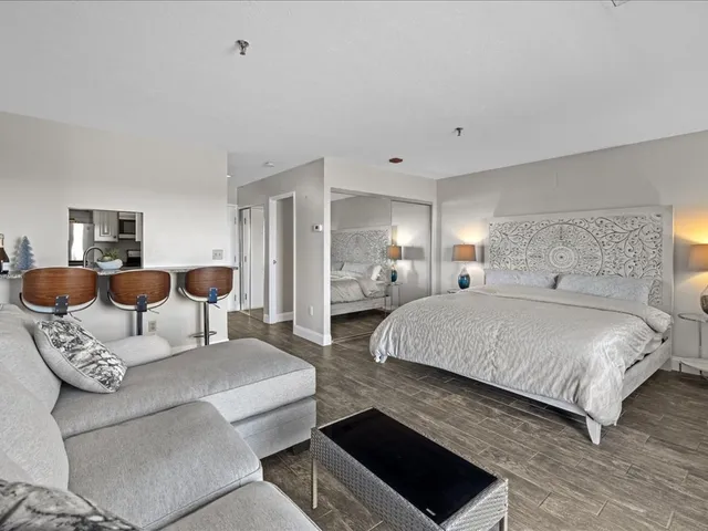 a living room with furniture and a floor to ceiling window