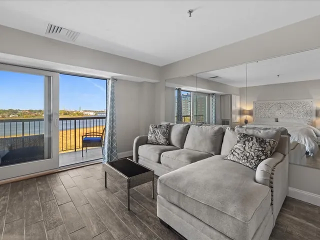 a living room with a large window and a fireplace