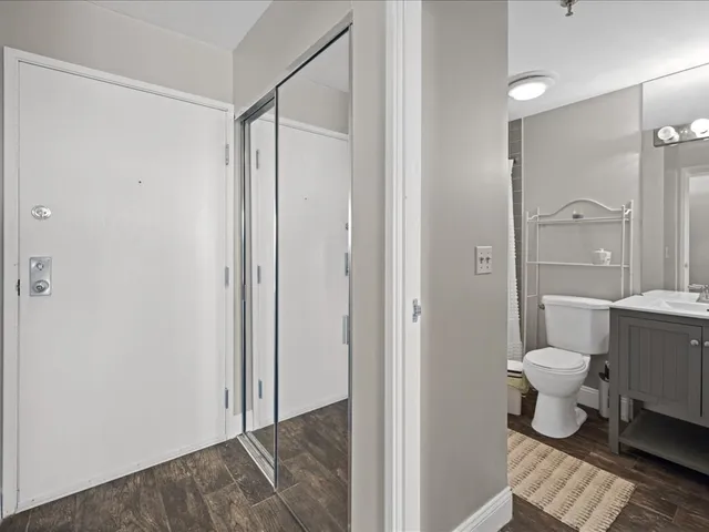 a bathroom with a toilet a sink and mirror