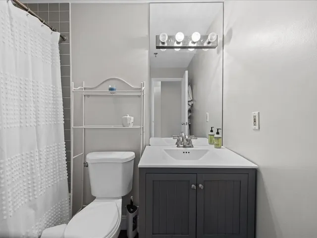 a kitchen with granite countertop a sink stove and refrigerator