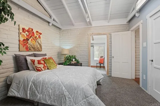 a bedroom with a bed and a potted plant