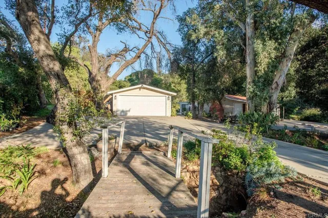 a view of a patio with table and chairs and potted plants
