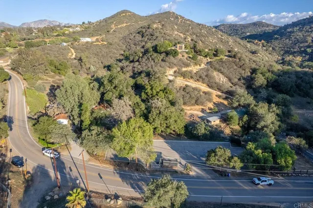 an aerial view of a house with a yard and garden