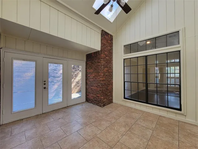 a view of an empty room with a cabinet and mirrors