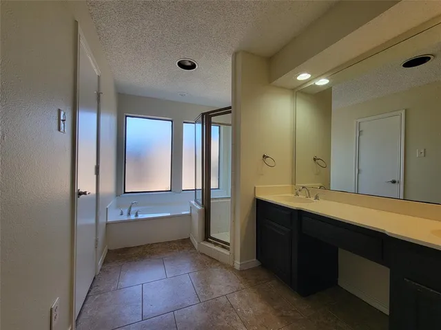 a bathroom with a bathtub sink and mirror