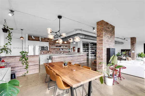 a dining room with furniture and wooden floor