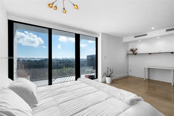a bedroom with a large bed and a large window