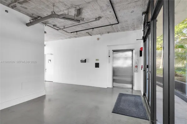 a view of a hallway with a glass door