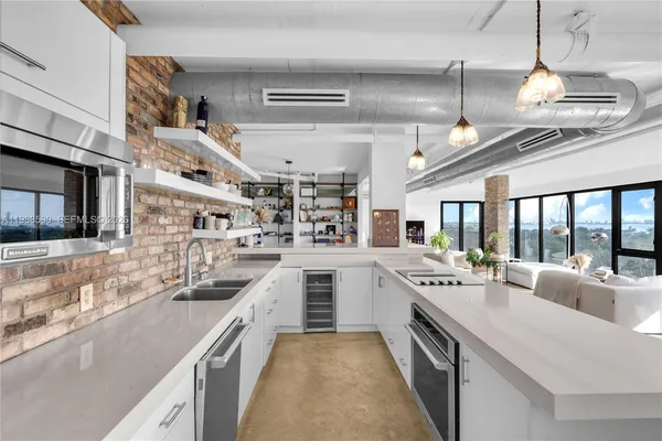 a large white kitchen with a large window