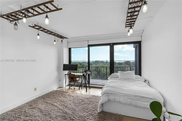 a bedroom with a large bed and a white bath tub