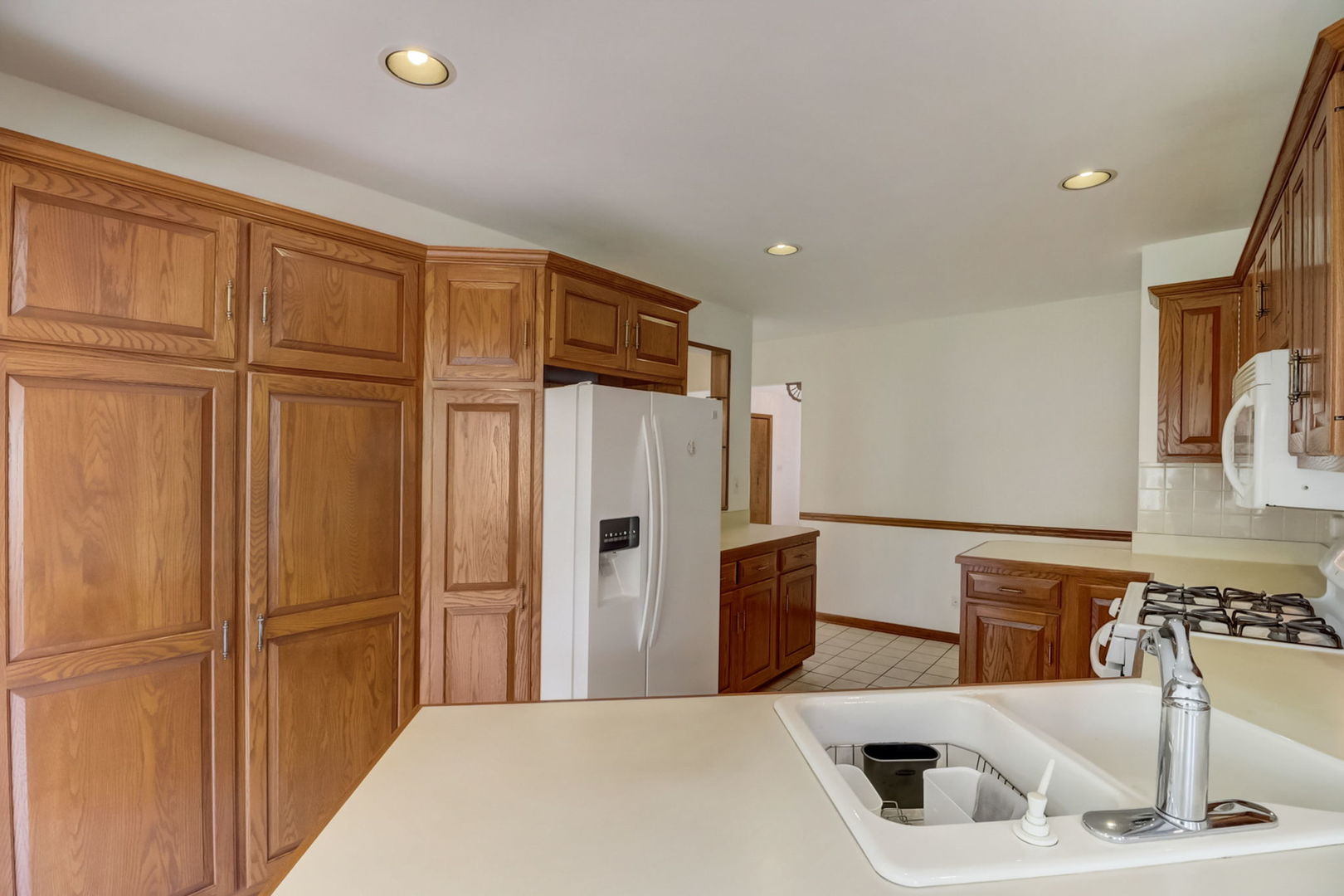 1125 Honey Hill Road Addison, IL 60101 - Photo 6 of 25 a kitchen with stainless steel appliances granite countertop a refrigerator and a sink