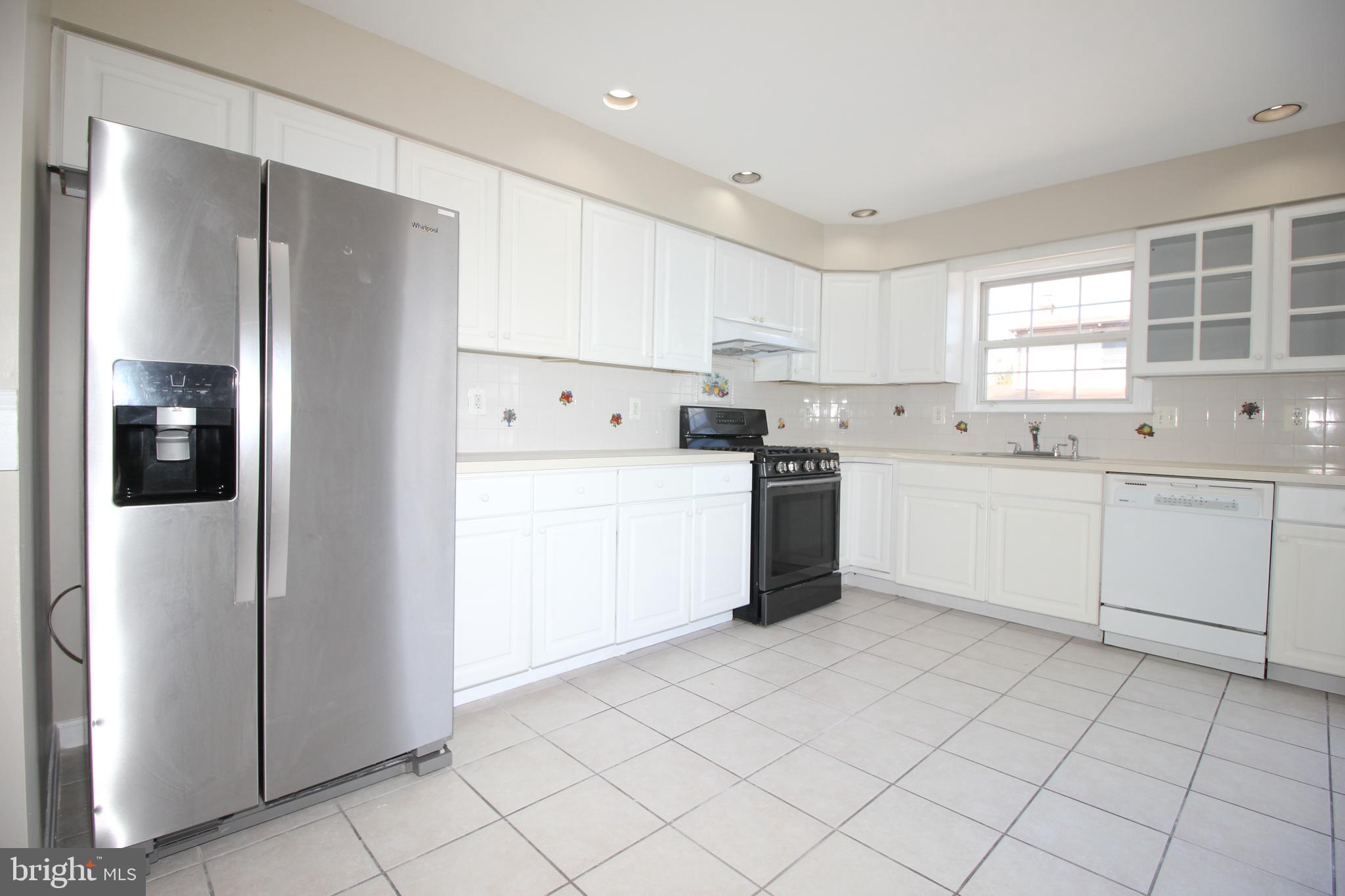 801 Taylor Street Riverside, NJ 08075 - Photo 11 of 34 a kitchen with white cabinets and white stainless steel appliances