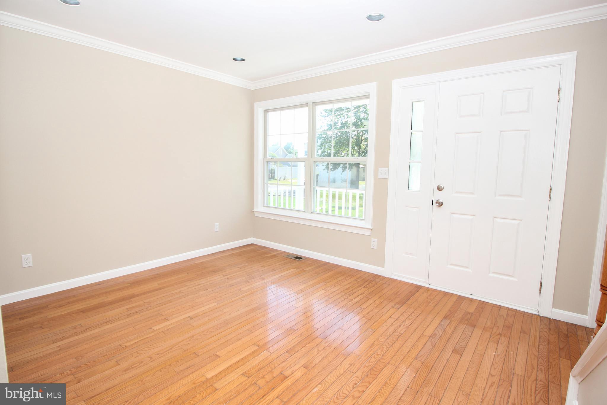 801 Taylor Street Riverside, NJ 08075 - Photo 6 of 34 an empty room with wooden floor and windows