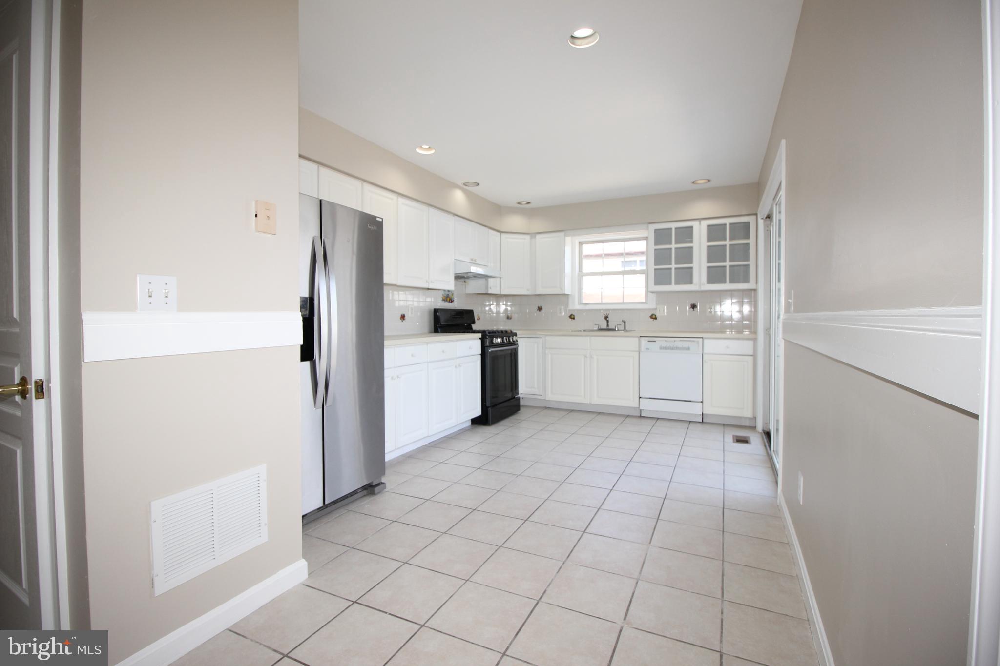801 Taylor Street Riverside, NJ 08075 - Photo 10 of 34 a kitchen with a refrigerator a stove top oven and cabinets