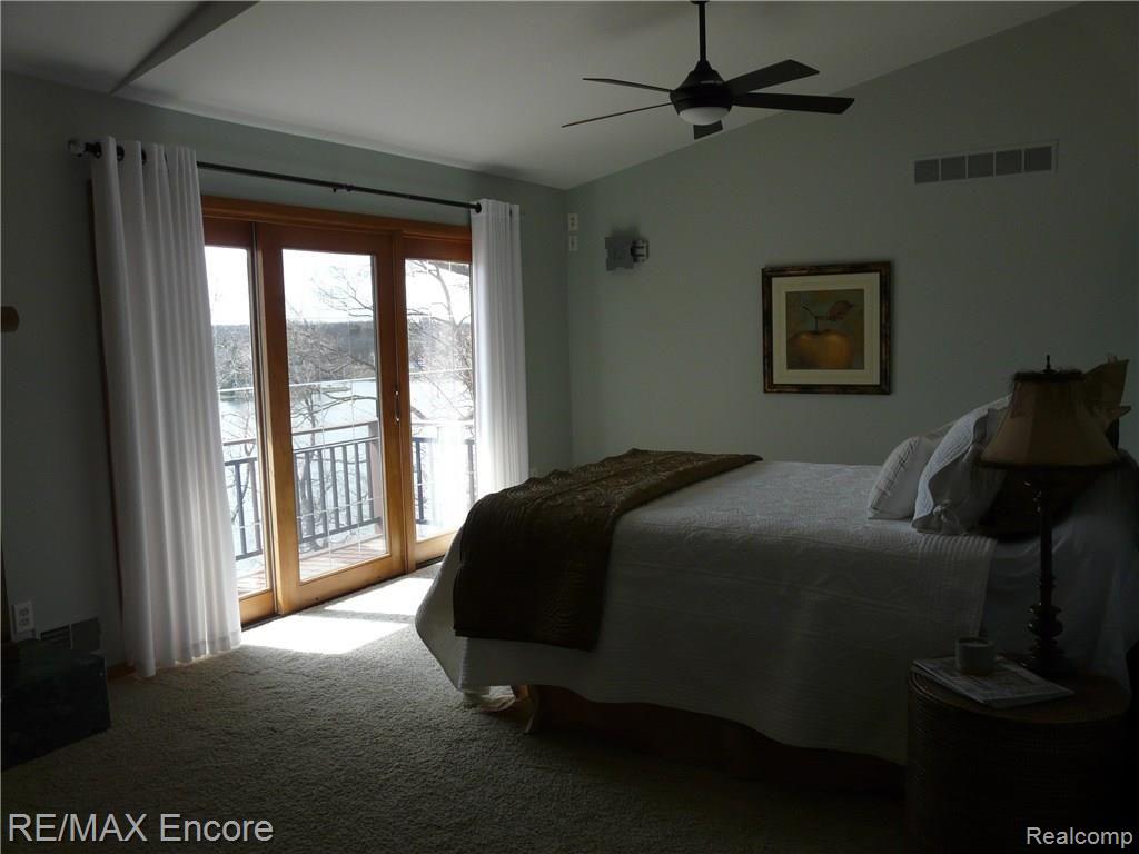 9589 Cherrywood Road Clarkston, MI 48348 - Photo 24 of 46 Master bedroom with private deck and lake views .