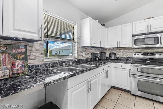 681-683 Alabama Road South, Unit 683 Lehigh Acres, FL 33974 - Photo 11 of 35 a kitchen with granite countertop a sink stainless steel appliances and cabinets