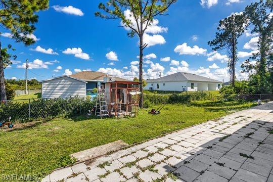 681-683 Alabama Road South, Unit 683 Lehigh Acres, FL 33974 - Photo 17 of 35 a view of a yard with plants and a fountain
