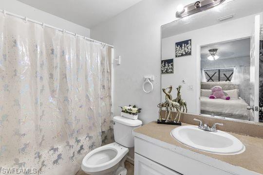 681-683 Alabama Road South, Unit 683 Lehigh Acres, FL 33974 - Photo 18 of 35 a bathroom with a granite countertop sink mirror vanity and toilet