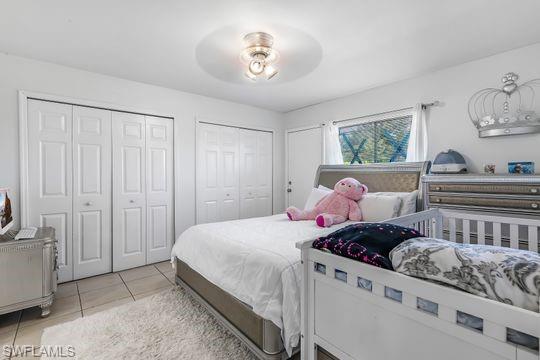 681-683 Alabama Road South, Unit 683 Lehigh Acres, FL 33974 - Photo 19 of 35 a bedroom with a bed and a chandelier