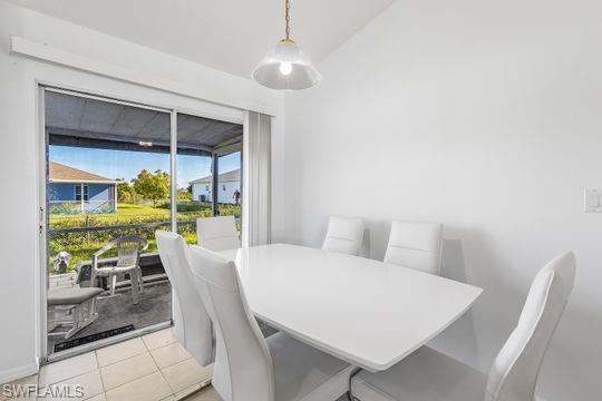 681-683 Alabama Road South, Unit 683 Lehigh Acres, FL 33974 - Photo 20 of 35 a view of a dining room with furniture wooden floor and chandelier