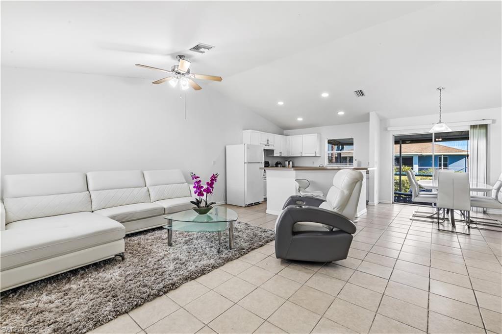 681-683 Alabama Road South, Unit 683 Lehigh Acres, FL 33974 - Photo 2 of 35 a living room with furniture and kitchen view