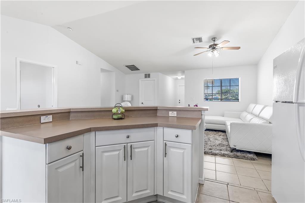 681-683 Alabama Road South, Unit 683 Lehigh Acres, FL 33974 - Photo 25 of 35 a kitchen with cabinets and window