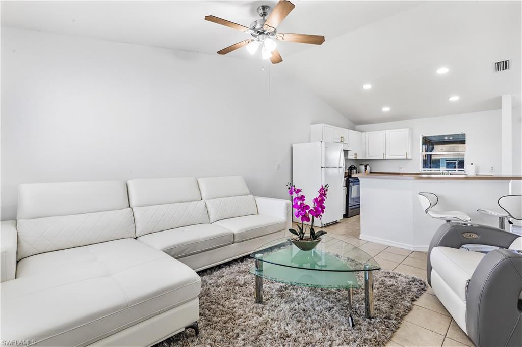 681-683 Alabama Road South, Unit 683 Lehigh Acres, FL 33974 - Photo 3 of 35 a living room with furniture and kitchen view