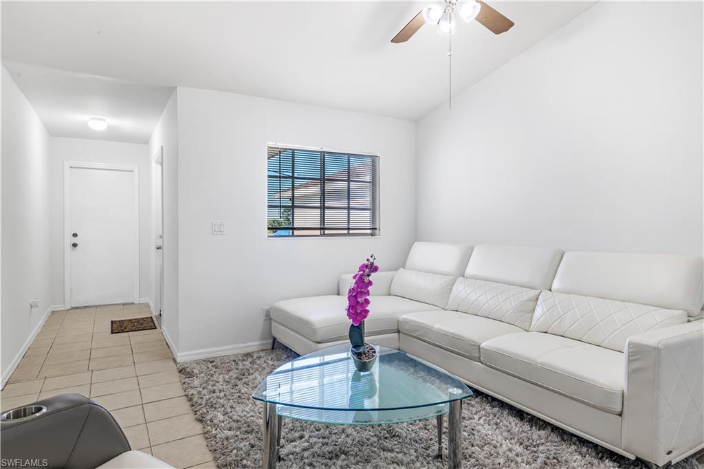 681-683 Alabama Road South, Unit 683 Lehigh Acres, FL 33974 - Photo 4 of 35 a living room with furniture and a chandelier