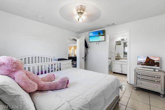 681-683 Alabama Road South, Unit 683 Lehigh Acres, FL 33974 - Photo 6 of 35 a bedroom with a bed and a chandelier