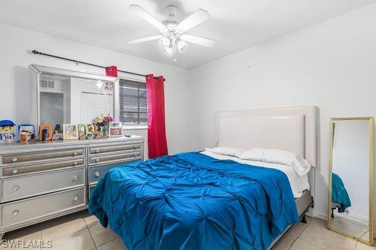 681-683 Alabama Road South, Unit 683 Lehigh Acres, FL 33974 - Photo 8 of 35 a bedroom with a large bed and a chandelier