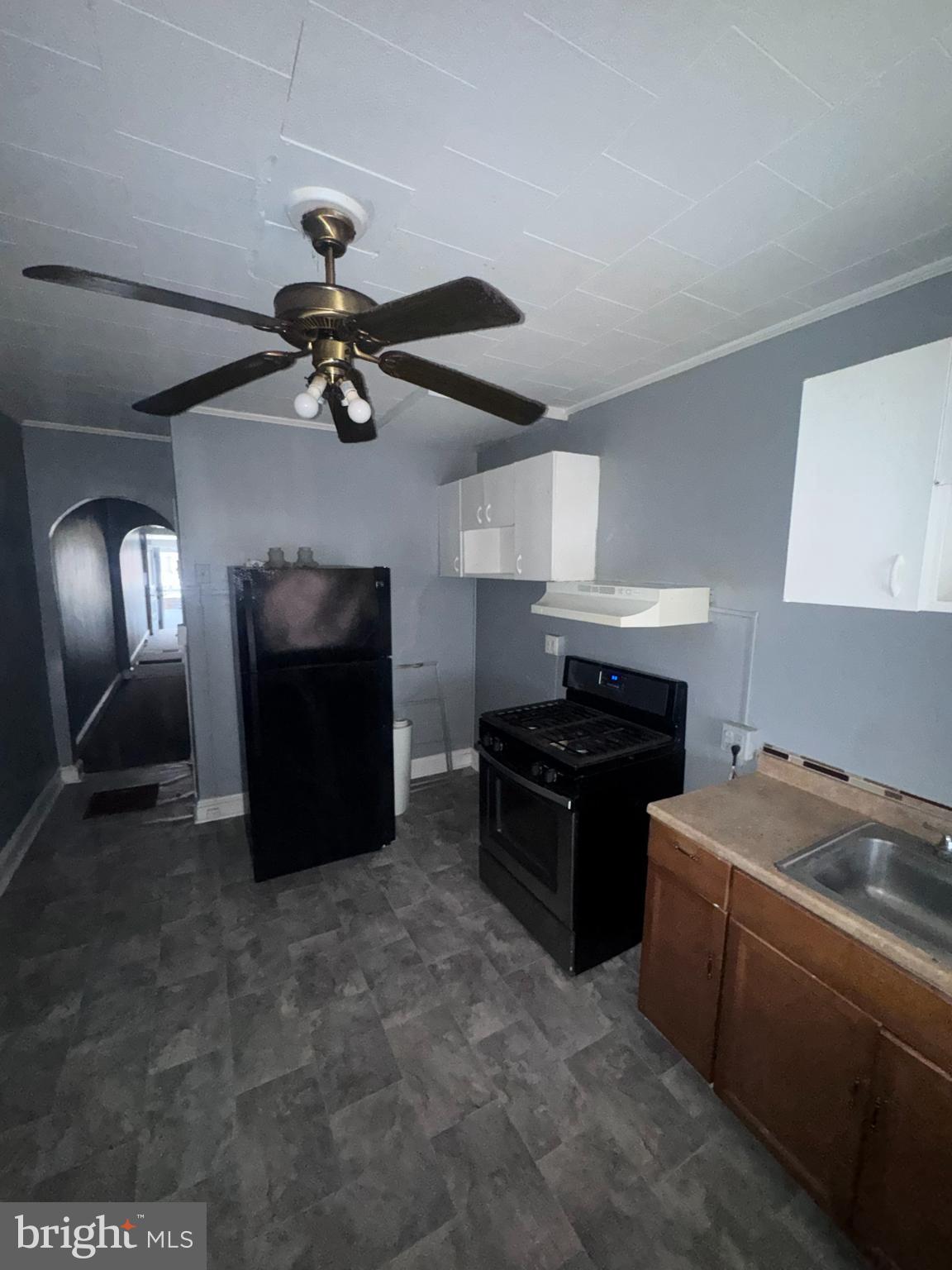 1812 North Payson Street Baltimore, MD 21217 - Photo 3 of 11 a kitchen with a stove and a refrigerator