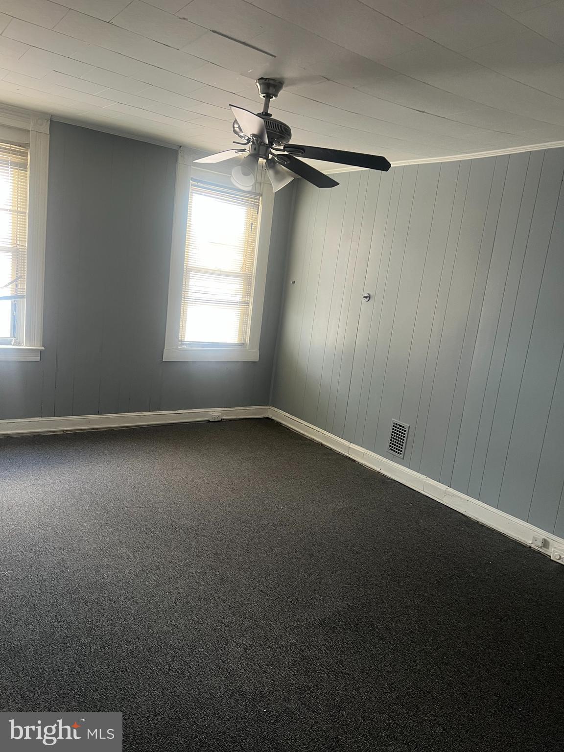1812 North Payson Street Baltimore, MD 21217 - Photo 5 of 11 an empty room with a window and a fan