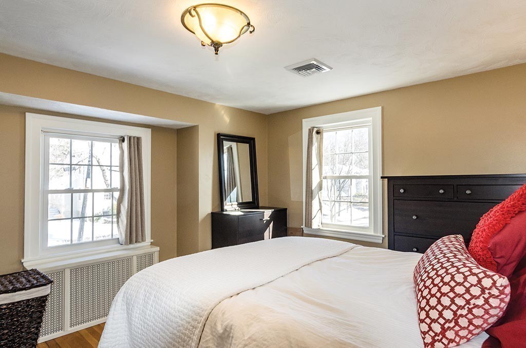 68 Bow Road Newton, MA 02459 - Photo 8 of 16 a bedroom with a bed and dresser with mirror