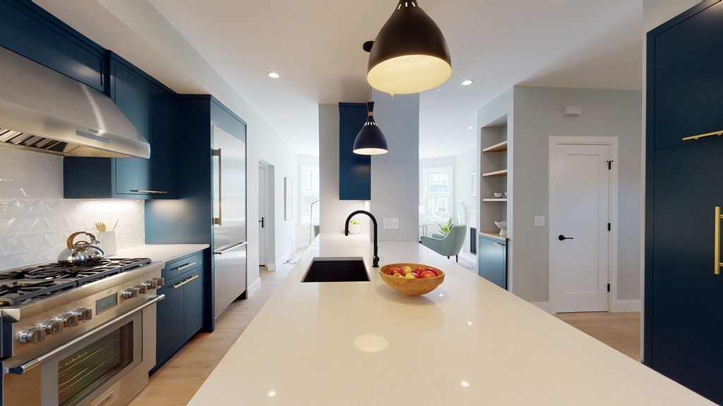 a kitchen with stainless steel appliances a sink a stove and refrigerator