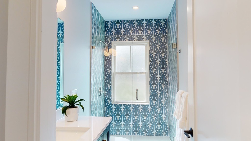 48 St John Street Boston, MA 02130 - Photo 12 of 25 a bathroom with a sink a mirror and a shower curtain