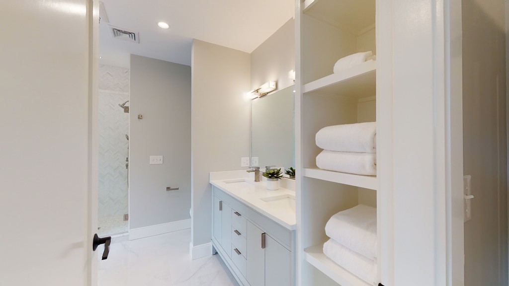 48 St John Street Boston, MA 02130 - Photo 13 of 25 a bathroom with a sink toilet double vanity and mirror